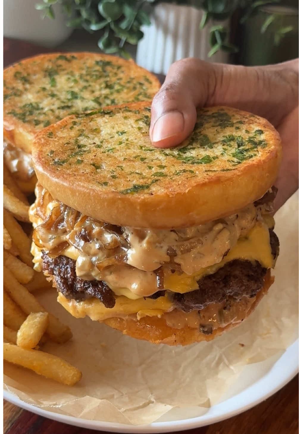 garlic bread smash burgers 🧄🍔✨ - cheesy smash burgers served w/ homemade burger sauce and caramelized onions then sand